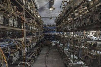 Image of a mining farm with rows of mining rigs